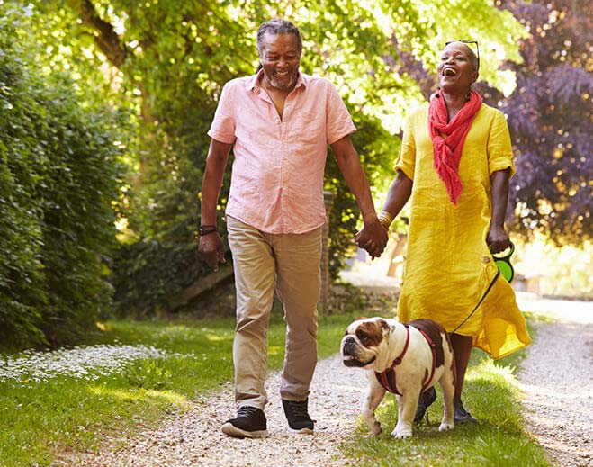 Senior Couple Walking Dog 