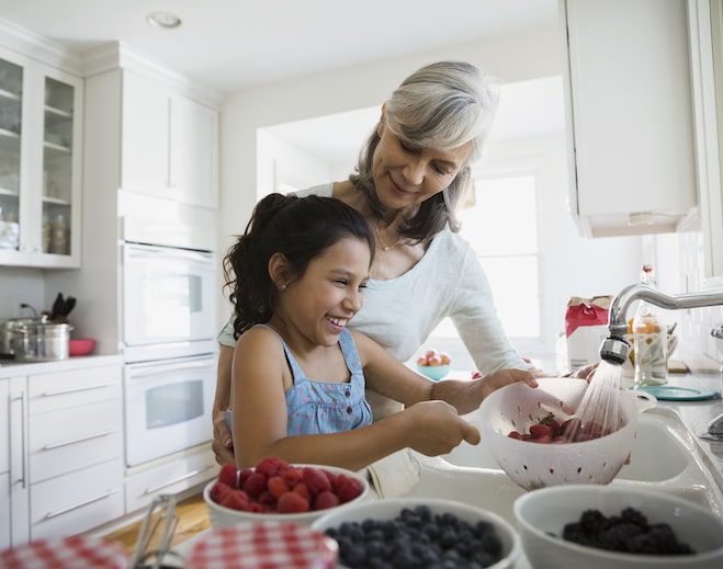 Grandma and child washing fruit