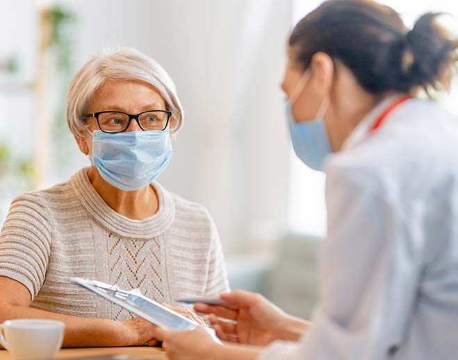 elderly lady talking to doctor