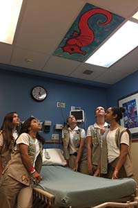 Girl Scouts looking at art on ceiling