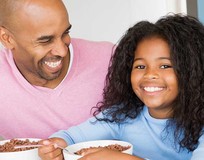 father-daughter-eating-cereal